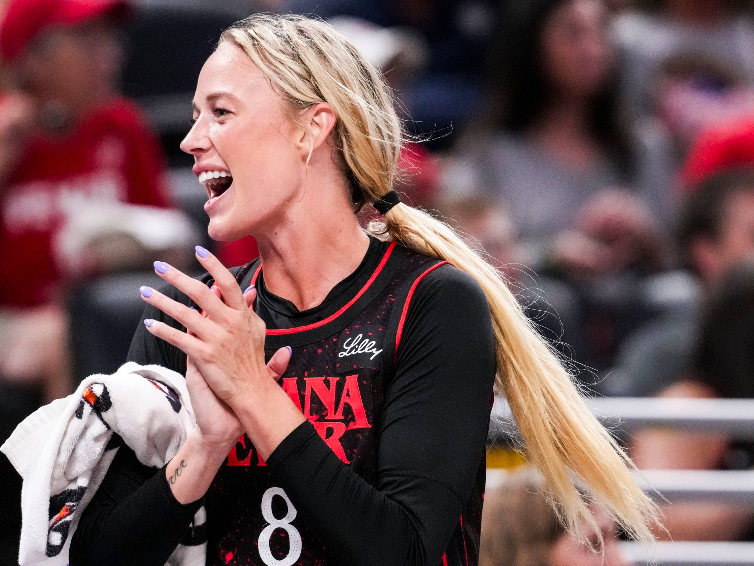 Indiana Fever guard Sophie Cunningham claps.