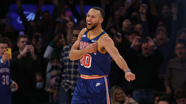 Golden State Warriors point guard Steph Curry celebrates his record setting three pointer.