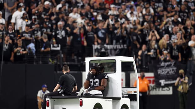 Gerald McCoy is carted off the field during a Raiders game.