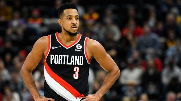 CJ McCollum stands with his hands on his hips.