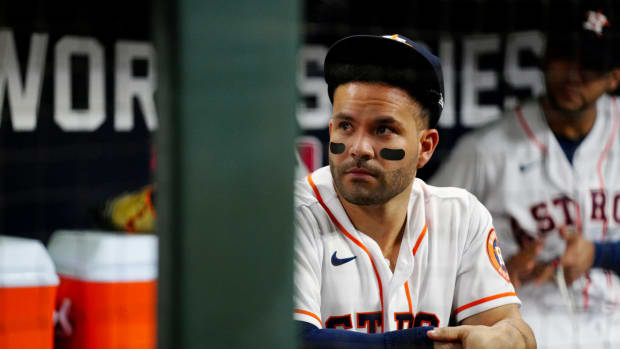 Jose Altuve sits in the Astros dugout.