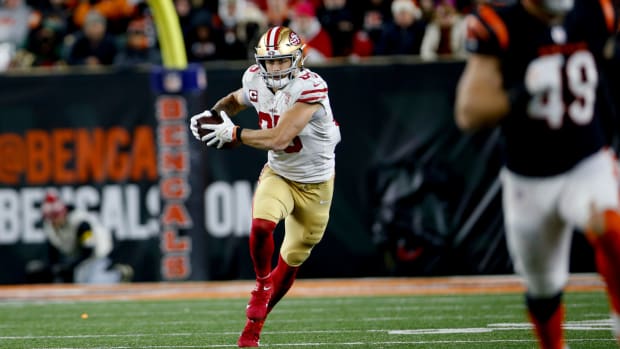 George Kittle runs with the ball.