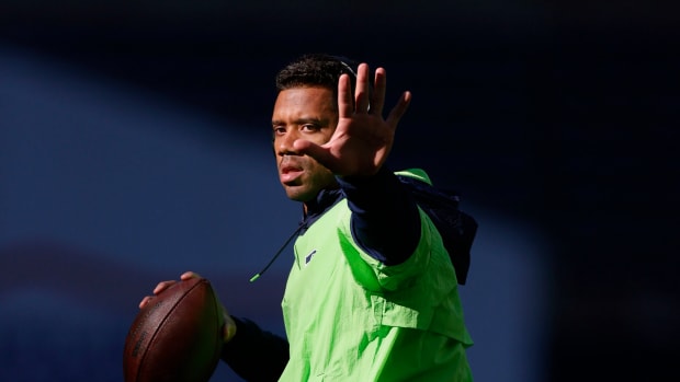Russell Wilson warms up on the field.