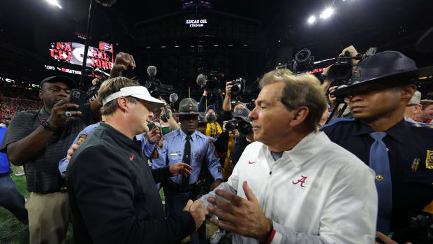 Nick Saban shaking hands with Kirby Smart.