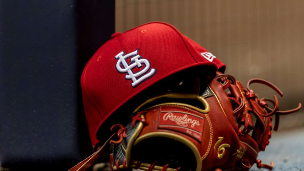 St. Louis Cardinals hat with a glove.
