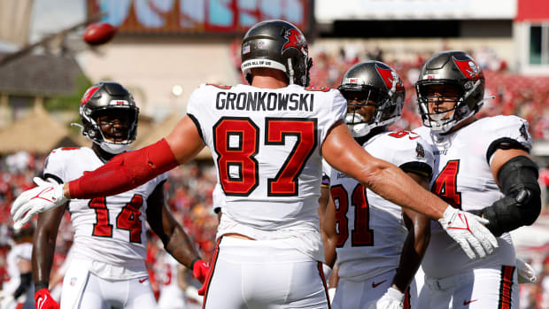 Rob Gronkowski embraces his Buccaneers teammates after scoring a touchdown.