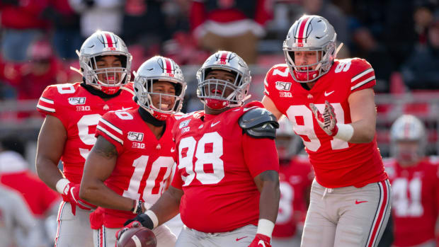 Ohio State defensive linemen celebrate a play during a college football game during the 2021 season.