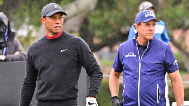 Tiger Woods and Phil Mickelson on the course.