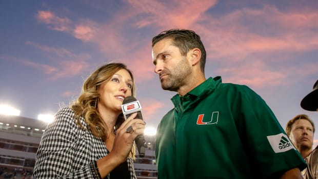 ESPN sideline reporter Allison Williams interviews Miami head coach Manny Diaz.