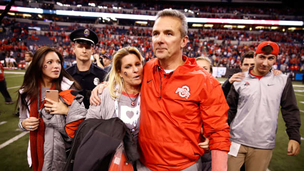Urban Meyer and his wife exit the field.