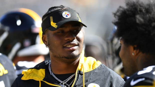 Steelers quarterback Dwayne Haskins looks on from the sidelines during a game.