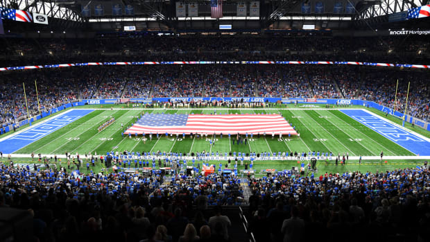 An American flag is held on the field at a Detroit Lions game.