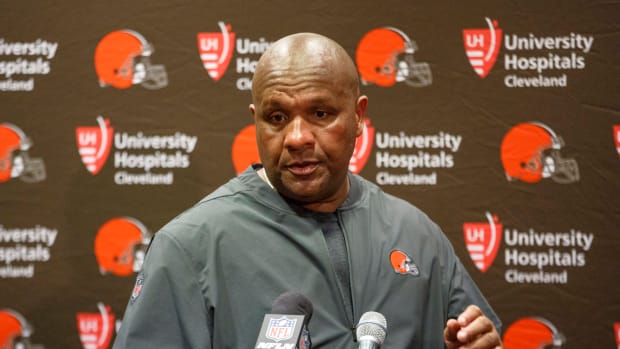 Hue Jackson stands at the podium during a press conference with the Browns.