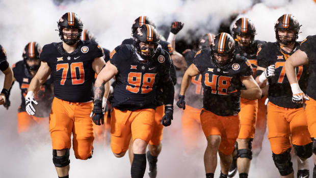 Oklahoma State players run out onto the field.