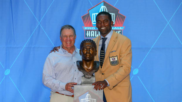 Bill Belichick and Randy Moss smile with Moss' Hall of Fame bust.