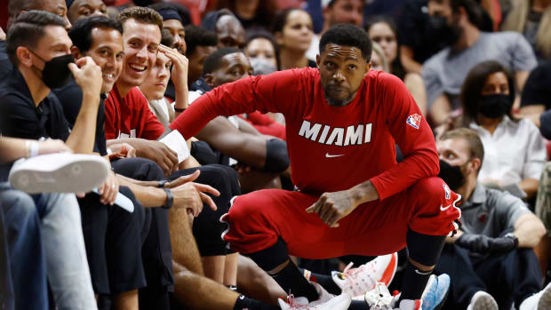 Miami Heat veteran Udonis Haslem crouches on the sideline.