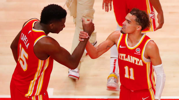 Trae Young and Clint Capela celebrate a Hawks win.
