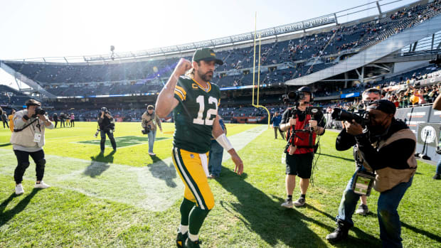 Aaron Rodgers runs off the field in Chicago after beating the Bears.
