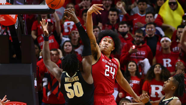 Rutgers' Ron Harper Jr. and Purdue's Trevion Williams battle for the ball.