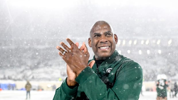 Michigan State head coach Mel Tucker smiles after a win in the snow.