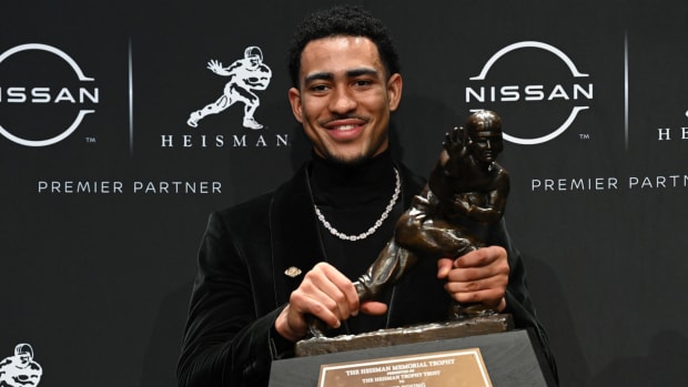 Alabama's Bryce Young holds up the Heisman Trophy.