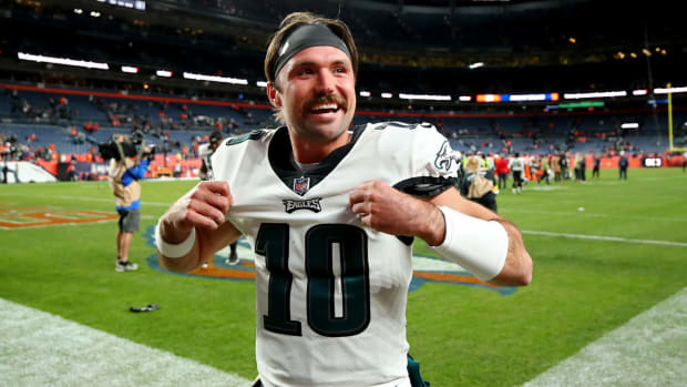 Eagles quarterback Gardner Minshew smiles while holding his jersey.