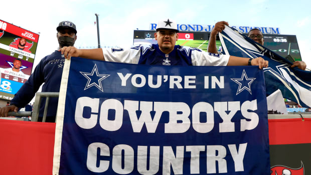 Dallas Cowboys fan holds a sign.