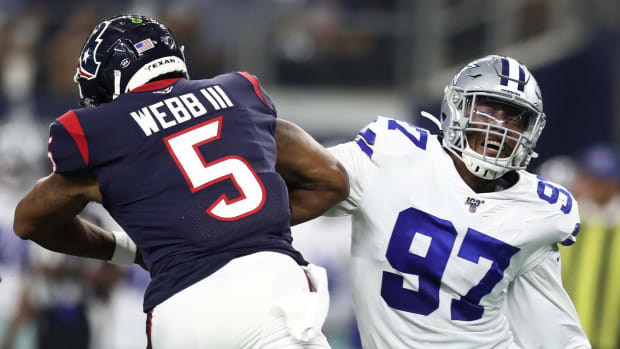Taco Charlton makes a tackle while playing for the Dallas Cowboys.