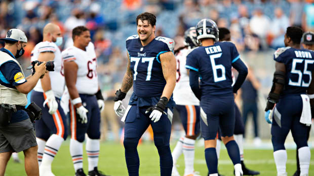Tennessee Titans tackle Taylor Lewan on the field ahead of a game.