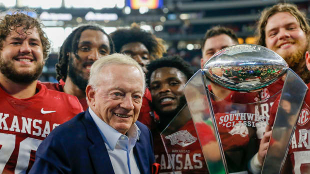 Jerry Jones celebrates with Arkansas football after a win at AT&T Stadium over Texas A&M.