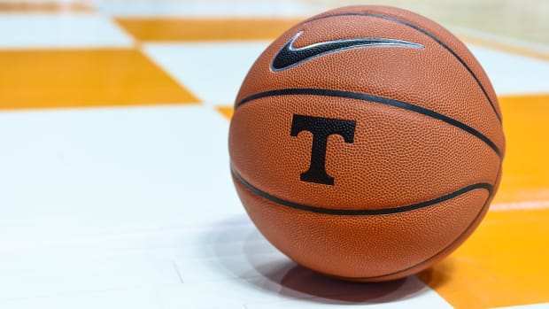 a basketball with the Tennessee logo rests on the court.
