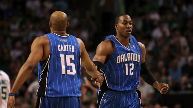 BOSTON - MAY 24:  (L-R) Vince Carter #15 and Dwight Howard #12 of the Orlando Magic  react to a play against the Boston Celtics in Game Four of the Eastern Conference Finals during the 2010 NBA Playoffs at TD Banknorth Garden on May 24, 2010 in Boston, Massachusetts.  NOTE TO USER: User expressly acknowledges and agrees that, by downloading and/or using this Photograph, user is consenting to the terms and conditions of the Getty Images License Agreement.  (Photo by Jim Rogash/Getty Images)