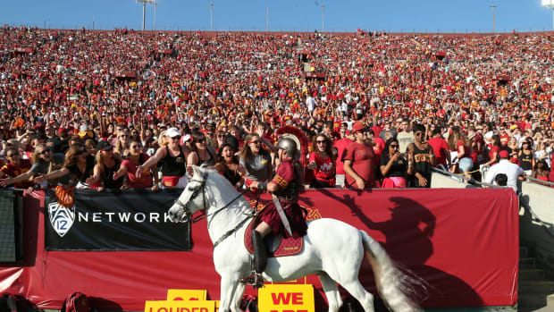 USC's mascot riding a horse and interacting with fans.