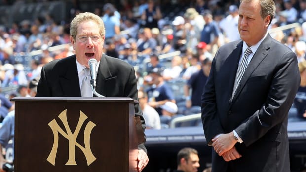 Yankee broadcasters John Sterling and Michael Kay speaking on the field at Yankee Stadium.