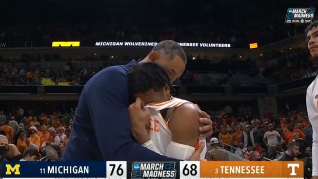 Juwan Howard consoles a Tennessee player in the handshake line.