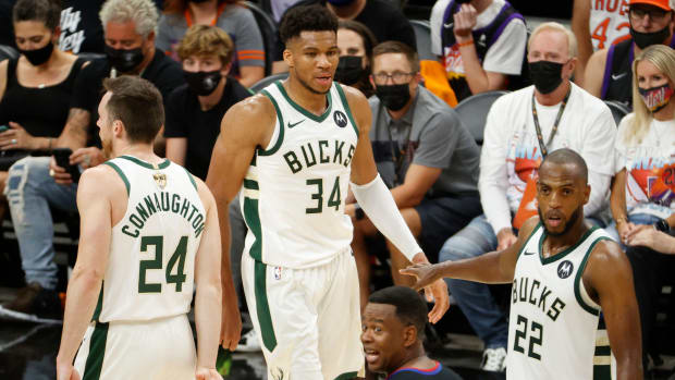 Giannis Antetokounmpo and the Bucks on the court in the Finals.