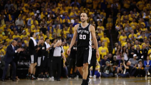 Manu Ginobli walking up the court.