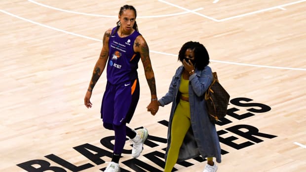 Brittney Griner and her wife on the floor.