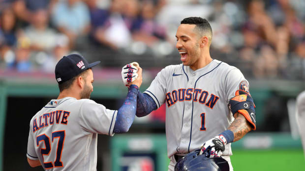 MLB stars Jose Altuve and Carlos Correa of the Houston Astros fist bump after a home run