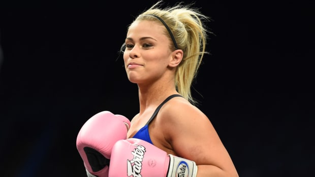 Paige VanZant in the ring with gloves.