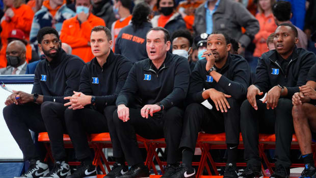 Duke coaches on the bench.