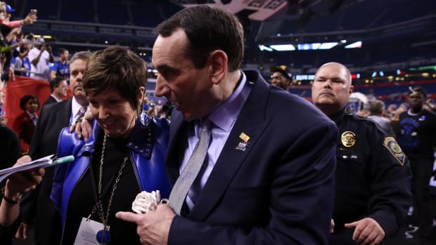 Coach K and his wife on the floor.