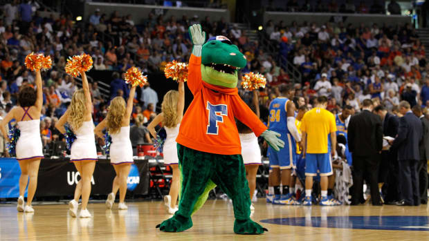 The Florida Gators mascot performing during a basketball game.