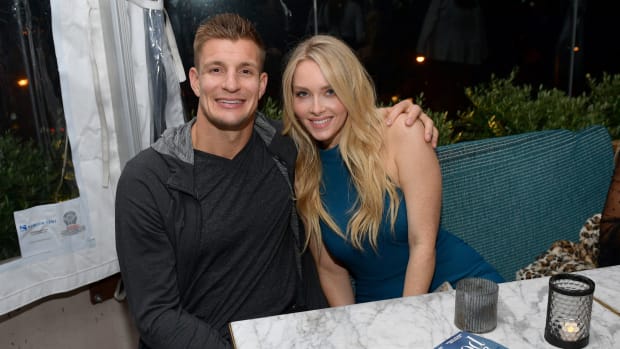 Rob Gronkowski and Camille Kostek pose for a photo.