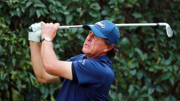 Phil Mickelson hitting a golf ball.