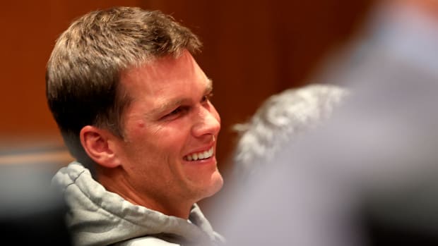 Bucs quarterback Tom Brady sits at a press conference for head coach Bruce Arians.