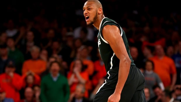 Former Michigan State men's basketball star Adreian Payne on the floor during a basketball game.