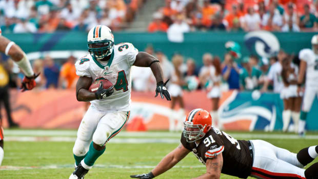 Ricky Williams runs the football for the Miami Dolphins.