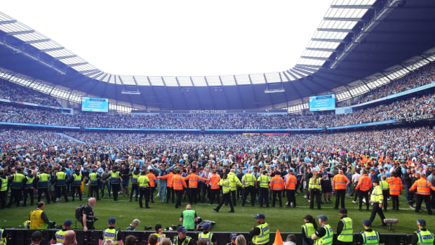 Manchester City fans celebrate during their Premier League title on Sunday afternoon.