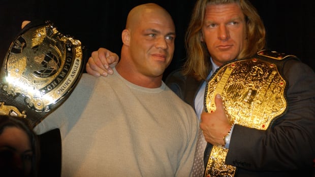 NEW YORK - MARCH 18:  World Wrestling Entertainment Wrestlers Kurt Angle (L) and Triple H attend a media conference announcing the all-star lineup of WWE WrestleMania XIX at ESPN Zone in Times Square March 18, 2003 in New York City.  (Photo by Mark Mainz/Getty Images)